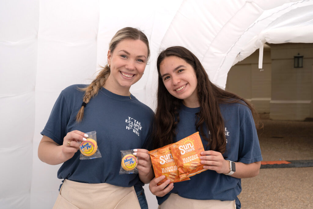 Two staff members who handed out Moon Pie and Sun Chips snacks.